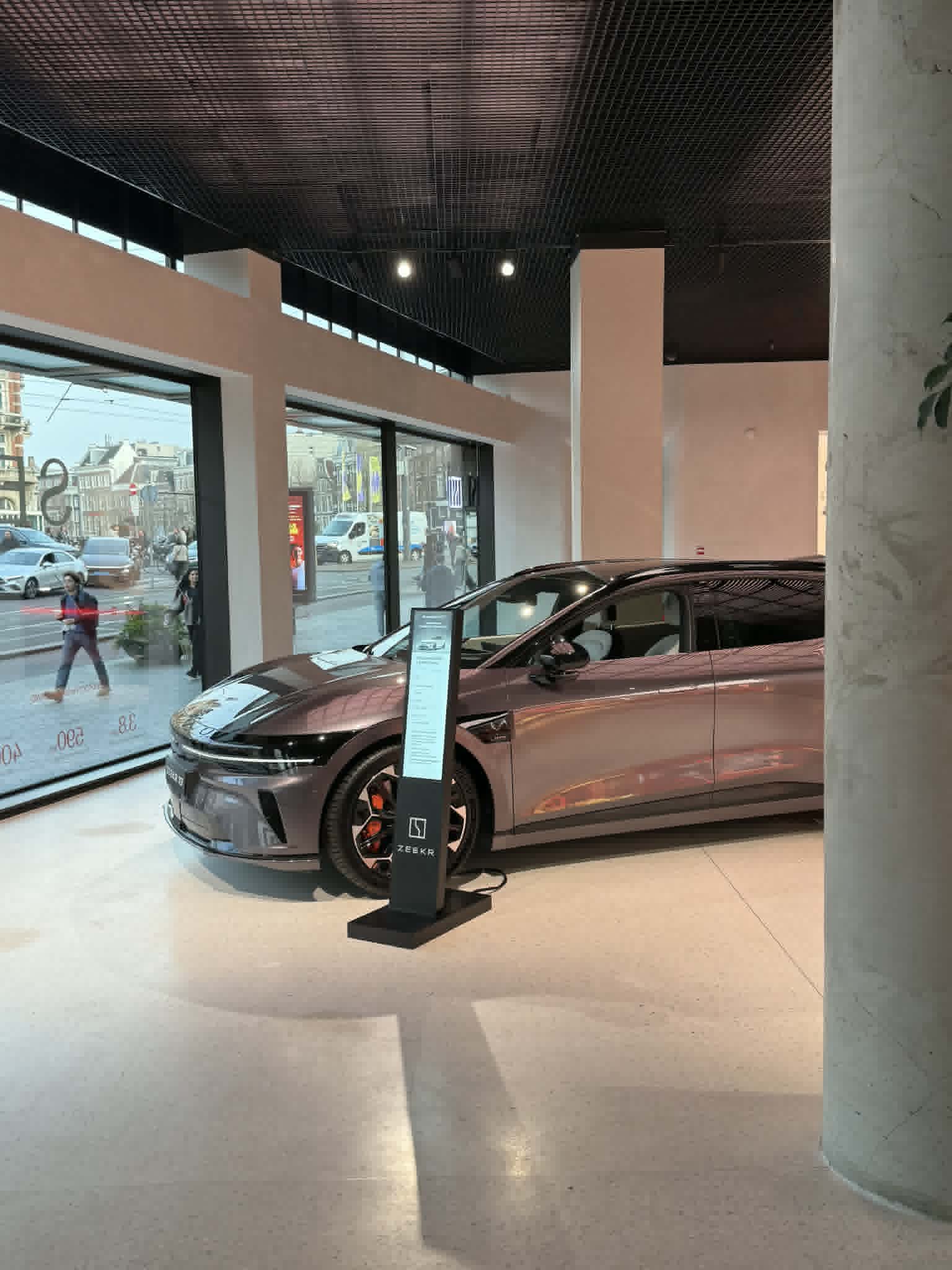 Zeekr showroom — LED totem beside vehicle
